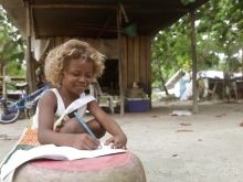 A girl writing outdoors